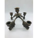 A wall mounted aged bronze coloured candle holder and a pewter coloured table candlestick to hold