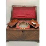 A mahogany tea caddy with glass mixing bowl and lion handles