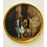 A painted plate signed by H.Millet bearing a coat of arms stamp for Sarreguemines depicting two men,