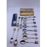 A collection of silver spoons including a few silver.