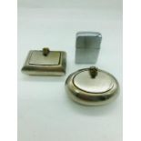 Two white metal pocket sized ashtrays and a Zippo lighter