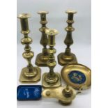 A selection of brassware to include four candlesticks, an incense burner and two small plates with