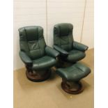 A pair of dark green leather "stress less" chairs by Norwegian company, Ekornes with one matching
