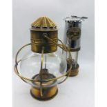 A miners lamp by E Thomas and Williams Ltd No 162184 and a circular brass oil lamp