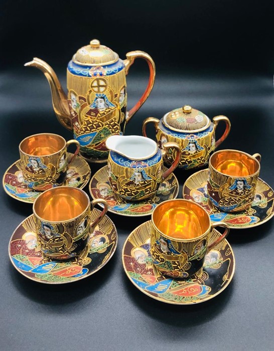 A Japanese hand painted tea set to include tea pot, milk jug, sugar bowl with lid, five saucers