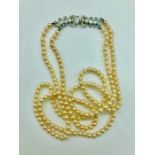 A Two strand pearl necklace with decorative fastener.
