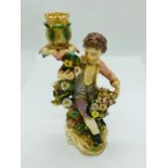 An 18th Century Meissen Candlestick in the form of a boy with a floral theme.