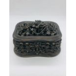 A decorative lidded box in a bronze gilt style