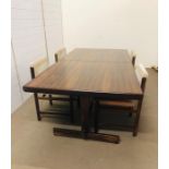 A mid century dining table on stretcher, with four matching chairs with upholstered seats and