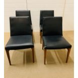 Four G-Plan chairs in black leatherette with gold stamp to base