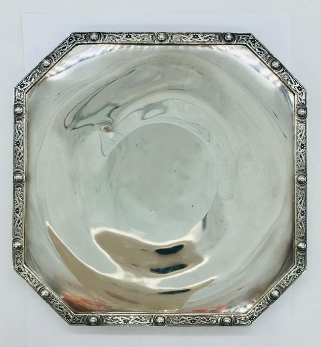 A Silver tray with ornate border.