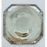 A Silver tray with ornate border.
