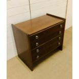 A four drawer mid century chest of drawers with interesting handles