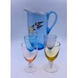 A coloured vintage jug and four glasses