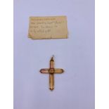 An early 20th Century cross in gold metal.