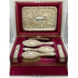 A Walker & Hall silver dressing table set, hallmarked Sheffield 1911, with seven pieces in velvet