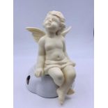 A Cherub, posed to sit on a ledge or shelf