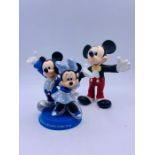 Two Disney theme Mickey and Minnie Mouse statues