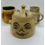 A fun Studio Pottery biscuit barrel decorated with a lady's face and a pair of jugs all signed to
