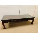 A oriental long glass top coffee table with dragon craved legs (H46cm W160cm D60cm)