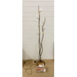 A floor standing metal light in the form of a plant