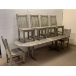 A one piece large wooden garden table with six slat back chairs (W270cm D109cm H70cm)