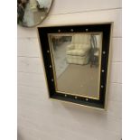 A square mid century wall mirror with cream spot details to frame