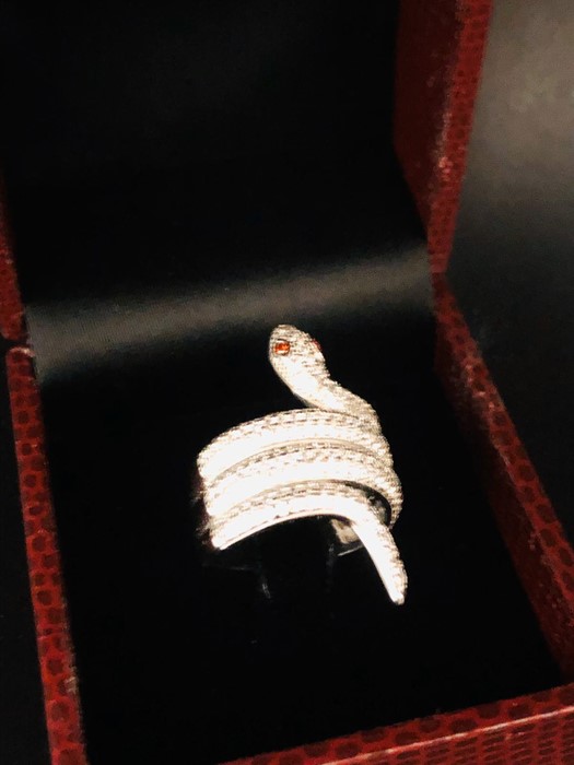 An unusual silver and CZ snake shaped ring.