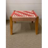 A mid century small stool with woven seat