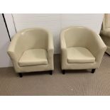 A pair of leather tub chairs
