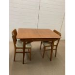 A Beautillion dining room table with centre leaf comes out to form a tea table along with two