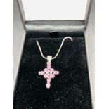 A Silver Cross Set with Ruby Coloured Stones on silver chain cased.
