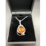 A Silver and Amber style pendant necklace on silver chain, cased.