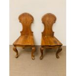 Two carved wooden hall chairs