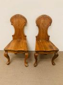 Two carved wooden hall chairs