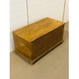 A pine blanket box with metal handles either end (H49cm D47cm W90cm)