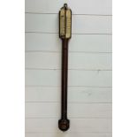 A wall mounted mahogany barometer.