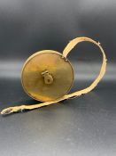 A Vintage Brass Tennis court measuring tape with the measurements and layout engraved on one side.
