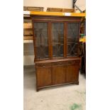 A library bookcase with glazed door to top and string inlay