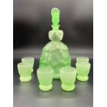 Green glass schnapps decanter in the figure of a women with six glasses