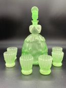 Green glass schnapps decanter in the figure of a women with six glasses