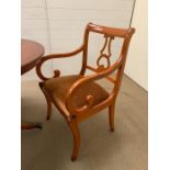 A regency style mahogany dining table with brass lion claw feet, with four chairs and two carvers (