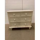 A two over two painted chest of drawers (H80cm W96cm D 45cm)