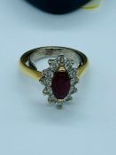 An 18ct yellow gold diamond and ruby cluster ring. Consisting of a heavy 18ct D section shank with