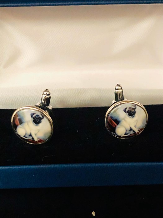 A Pair of Silver and Enamel Set Cuff links depicting a Pug Dog