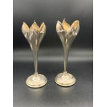 A pair of silver plated tulip bud vases