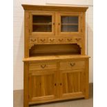 An oak dresser with glazed doors with cupboard under (H210cm W146cm D54cm)