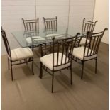 A metal framed dining table with glass top and six chairs (H78cm W168cm D106cm)