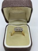 An 18ct yellow gold diamond set cluster ring. Consisting of wide flat section shank in yellow