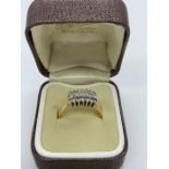 An 18ct yellow gold diamond set cluster ring. Consisting of wide flat section shank in yellow